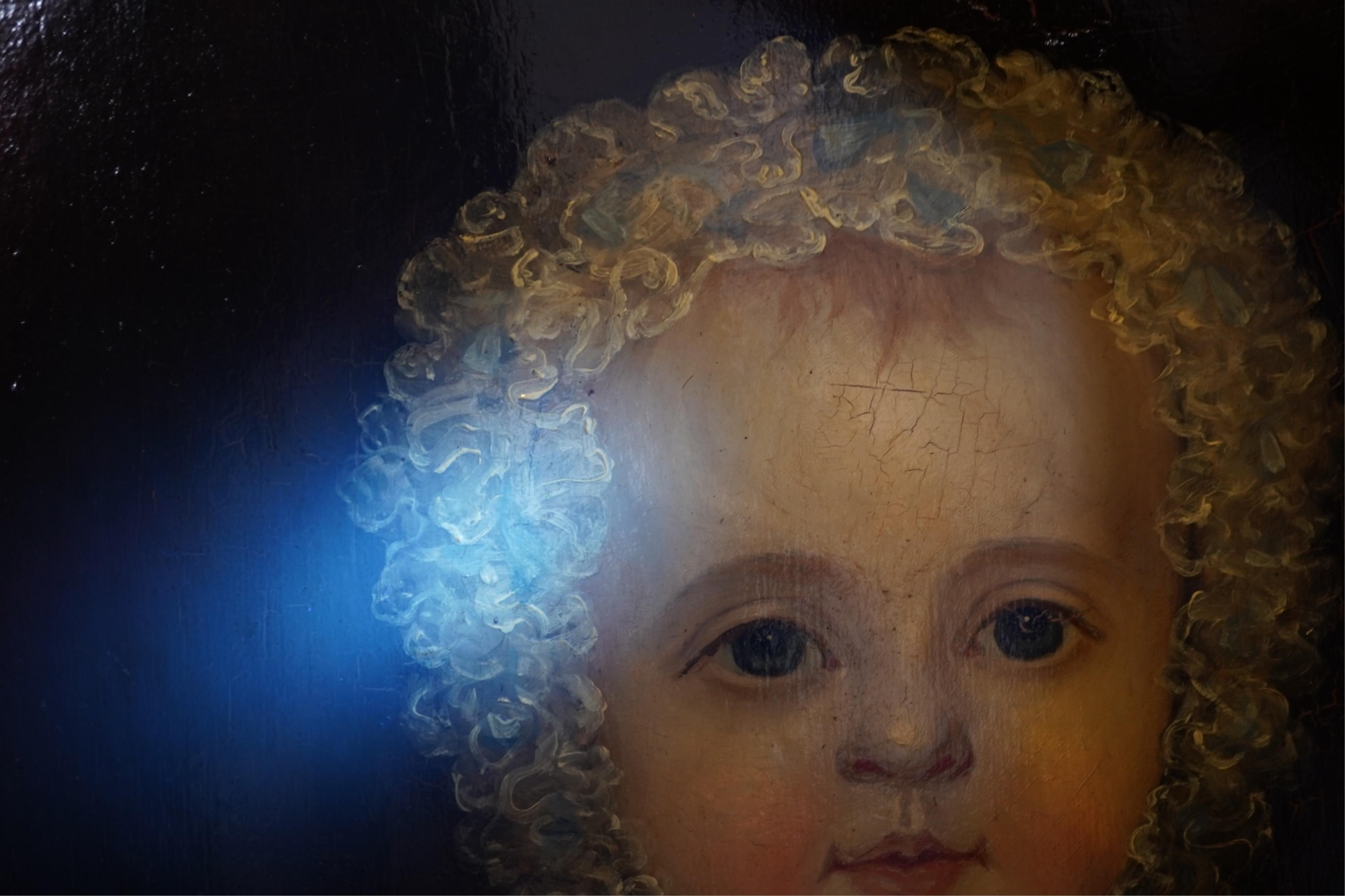 English School c.1840 , Portrait of an infant wearing a coral necklace and holding a silver rattle, oil on board, 42 x 35cm